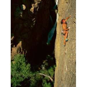 Rock Climber Scales the Vertical Face of a Mountain Photographic 