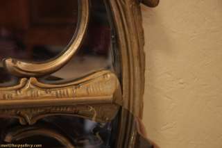 Richly hand carved in gold, this hall mirror has an attached walnut 